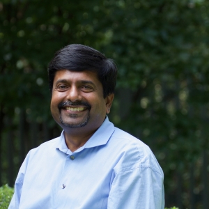 headshot of Senior Minister Abhi Janamanchi in Cedar Lane's courtyard